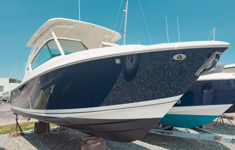 Slide: The Image of 2020 Pursuit DC 266 Dual Console boat on display, featuring sleek design and modern amenities. - 2