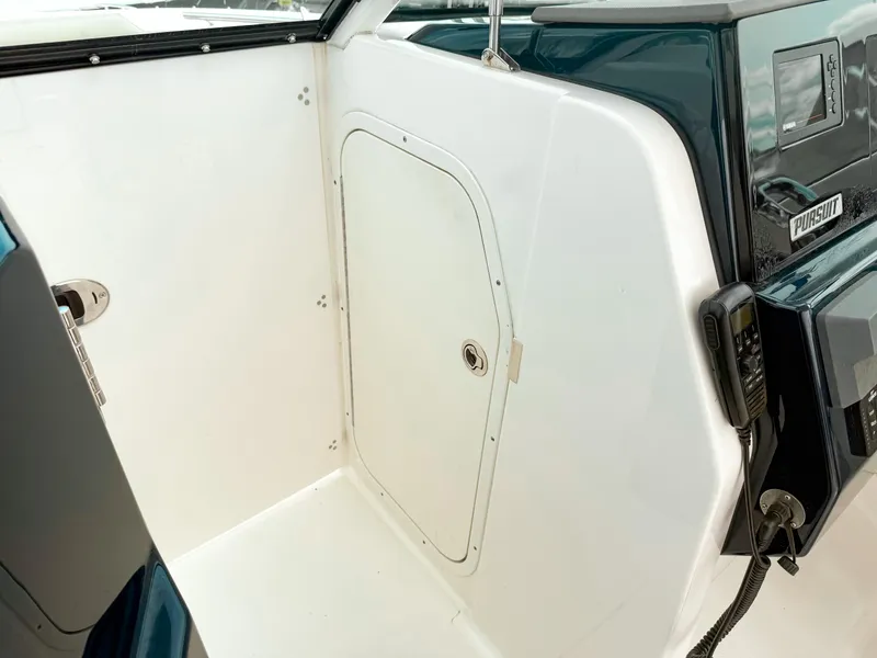 Slide: The Image of 2020 Pursuit DC 266 Dual Console interior with storage compartment and control panel. - 21