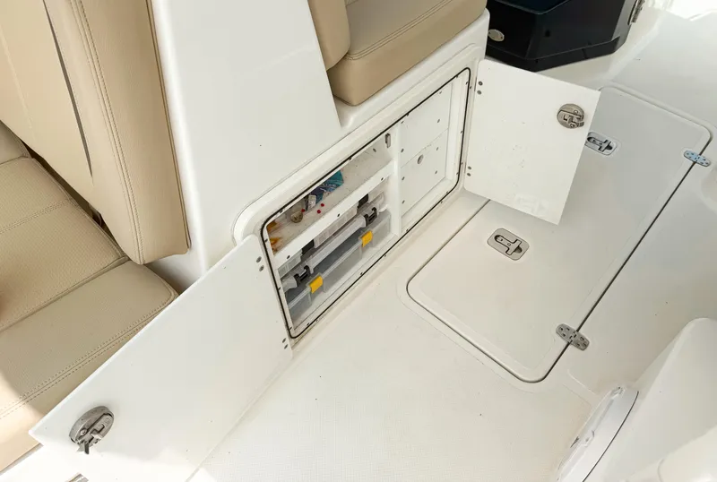Slide: The Image of 2020 Pursuit DC 266 Dual Console boat interior with open storage compartment. - 26