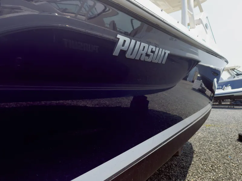 Slide: The Image of 2020 Pursuit DC 266 Dual Console boat, sleek design, close-up view. - 5