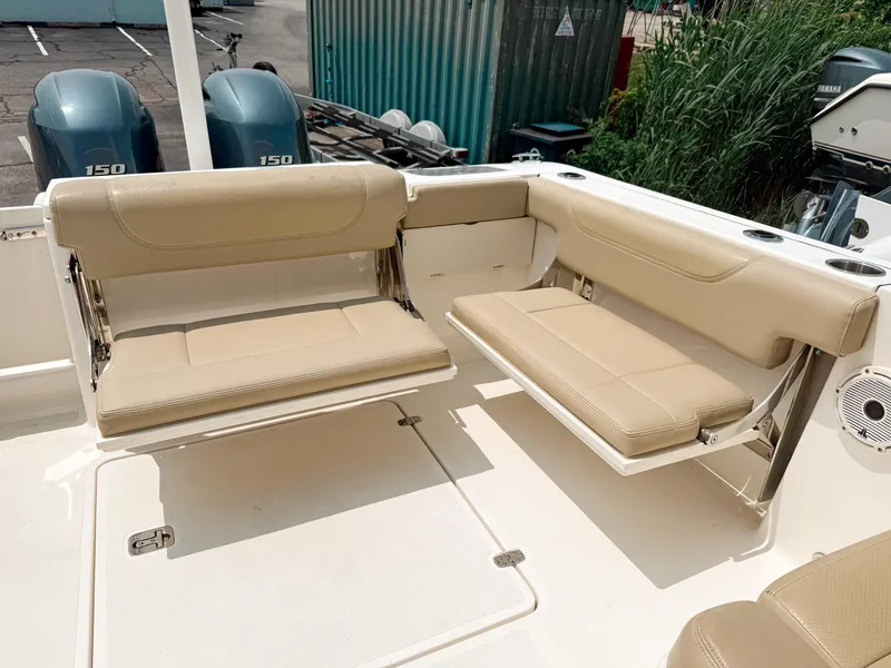 Slide: The Image of 2020 Pursuit DC 266 Dual Console boat with beige seating and twin 150 engines. - 8