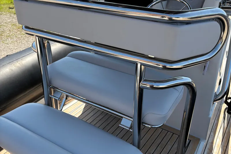 Slide: The Image of 2013 Protector 25 Center Console boat seating with chrome details and cushioned seats. - 13