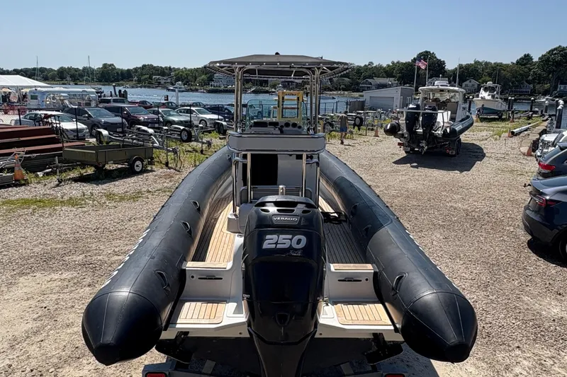 Slide: The Image of 2013 Protector 25 Center Console boat with 250 horsepower engine, docked near waterfront. - 4