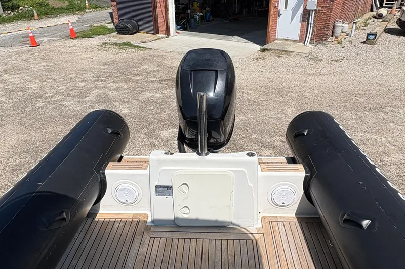 Slide: The Image of 2013 Protector 25 Center Console boat with outboard motor and inflatable tubes. - 6