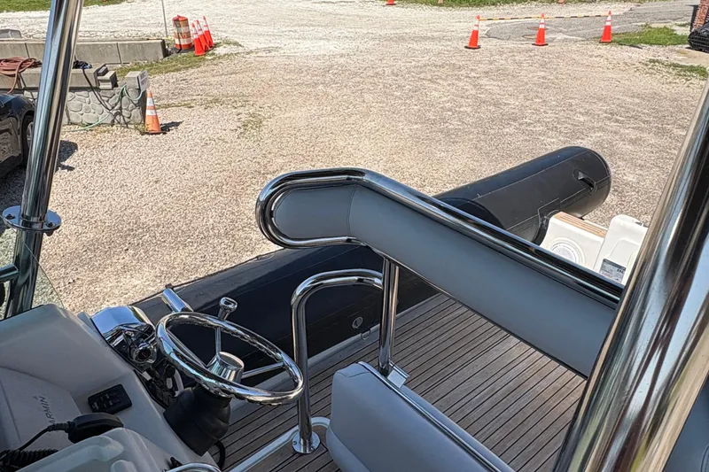 Slide: The Image of 2013 Protector 25 Center Console boat interior with steering wheel and seating. - 9