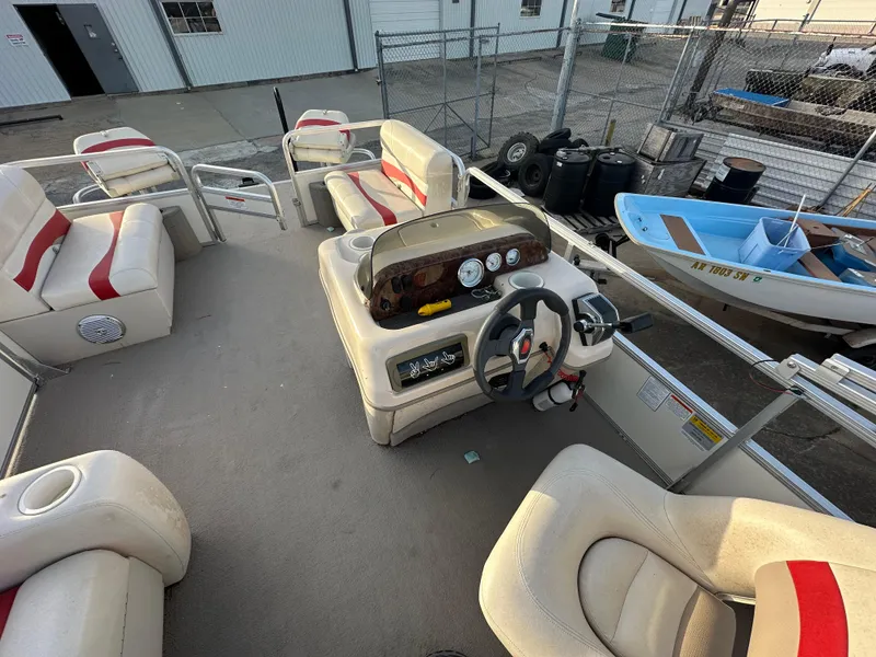 Slide: The Image of 2009 Sun Tracker PARTY BARGE 200 Classic Series interior with beige seating and control console. - 11