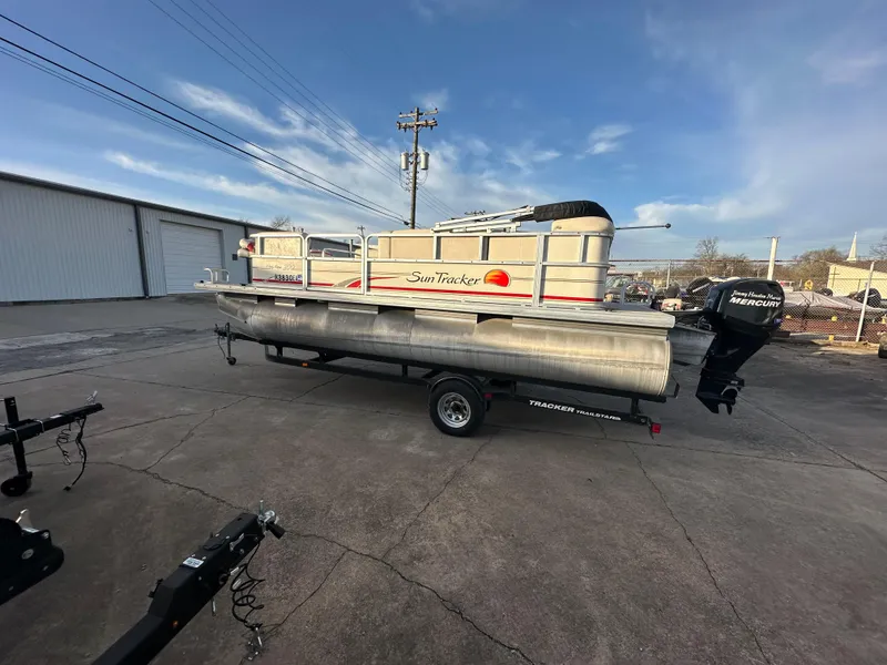 Slide: The Image of 2009 Sun Tracker PARTY BARGE 200 Classic pontoon boat on trailer, parked outdoors. - 3