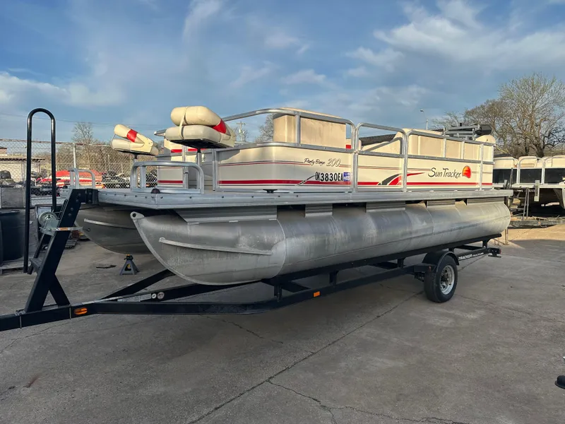 Slide: The Image of 2009 Sun Tracker PARTY BARGE 200 Classic pontoon boat on trailer, parked outdoors. - 6