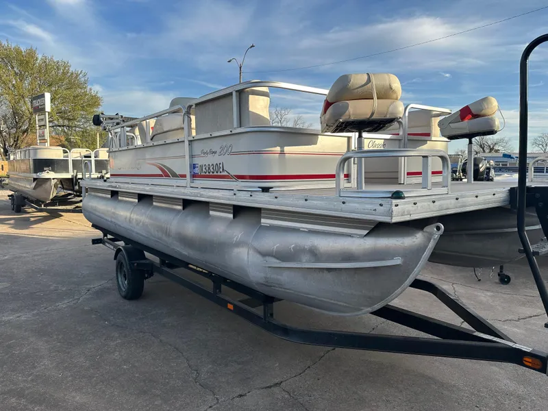 Slide: The Image of 2009 Sun Tracker PARTY BARGE 200 Classic pontoon boat on trailer, parked outdoors. - 7
