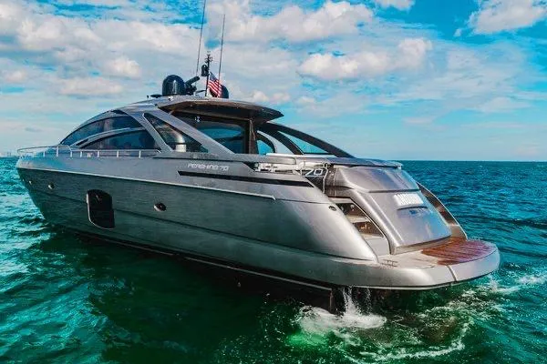 Slide: The Image of Luxury 2015 Pershing 70 yacht cruising on open sea under blue sky. - 1