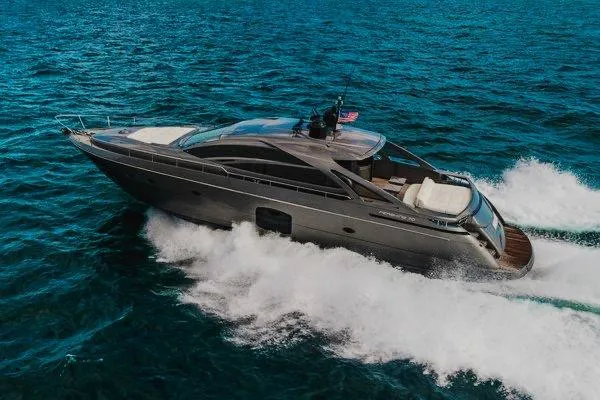 Slide: The Image of 2015 Pershing 70 yacht cruising on open sea, showcasing sleek design and powerful performance. - 12