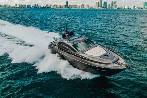 Slide: The Image of 2015 Pershing 70 yacht cruising on ocean with city skyline in background. - 16