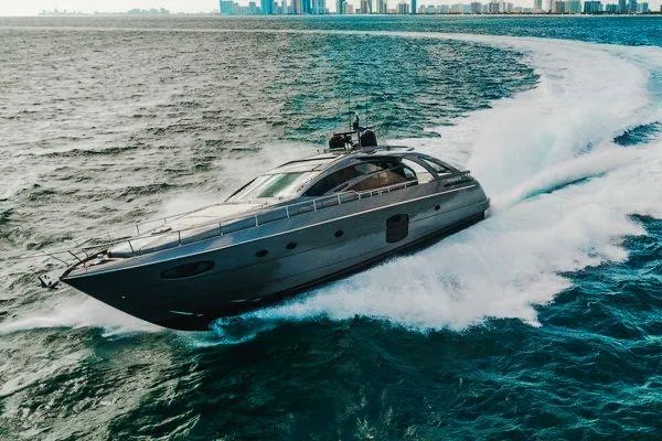 Slide: The Image of Luxury Pershing 70 yacht cruising on open water, city skyline in background, 2015 model. - 18