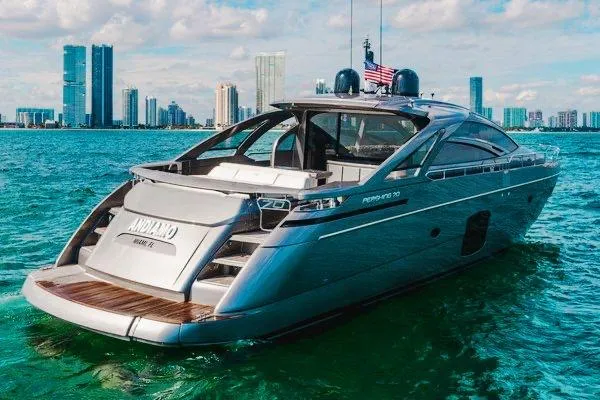 Slide: The Image of Luxury 2015 Pershing 70 yacht cruising near city skyline on a sunny day. - 2