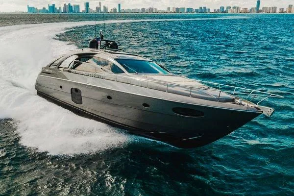 Slide: The Image of Luxury 2015 Pershing 70 yacht cruising on open water near city skyline. - 21