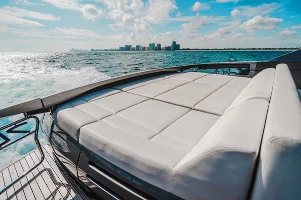 Slide: The Image of Luxurious 2015 Pershing 70 yacht with sunbed, cruising on open water under a bright sky. - 28