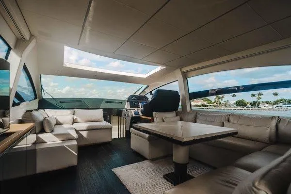 Slide: The Image of Luxurious interior of a 2015 Pershing 70 yacht with plush seating and panoramic windows. - 37
