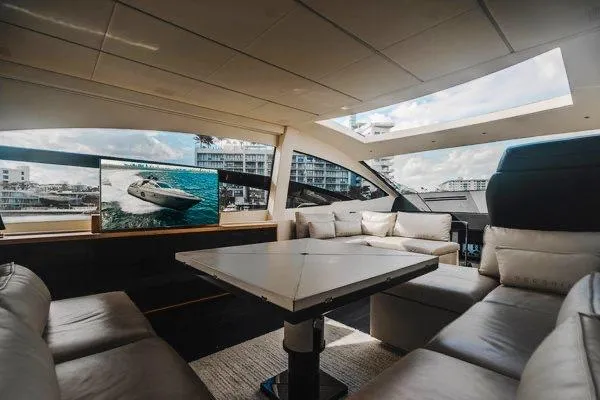 Slide: The Image of Luxurious interior of a 2015 Pershing 70 yacht with modern seating and large windows. - 39