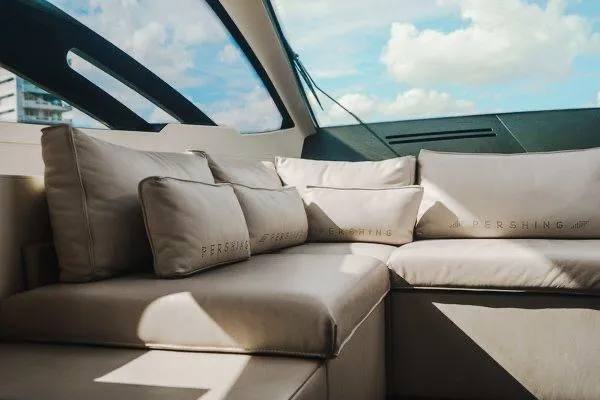 Slide: The Image of Luxurious interior of a 2015 Pershing 70 yacht with plush seating and cushions. - 40