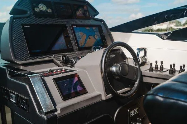 Slide: The Image of Cockpit of 2015 Pershing 70 yacht with advanced navigation systems and steering wheel. - 43