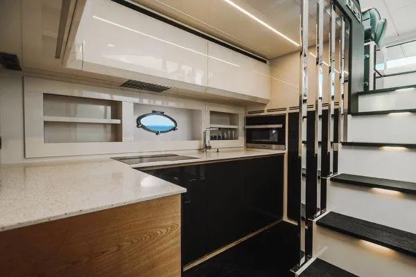 Slide: The Image of Luxurious kitchen interior of a 2015 Pershing 70 yacht, featuring modern design and sleek finishes. - 44
