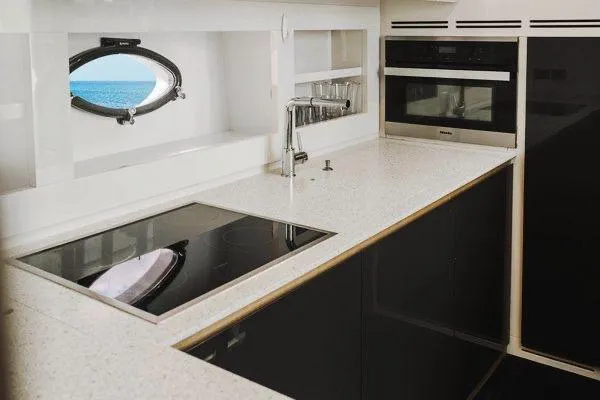 Slide: The Image of Modern kitchen interior on 2015 Pershing 70 yacht, featuring sleek appliances and ocean view. - 45