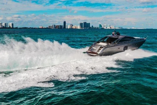 Slide: The Image of 2015 Pershing 70 yacht cruising on ocean with city skyline in background. - 8