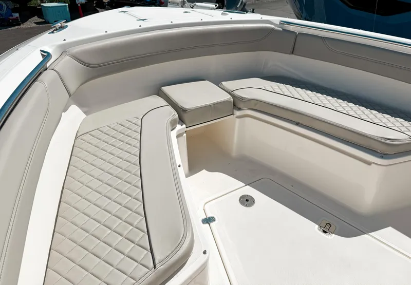 Slide: The Image of 2024 Pursuit S 288 Sport boat interior with cushioned seating and sleek design. - 11