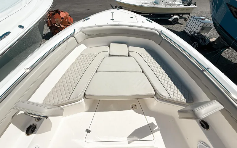 Slide: The Image of 2024 Pursuit S 288 Sport boat interior with cushioned seating and diamond-patterned upholstery. - 12