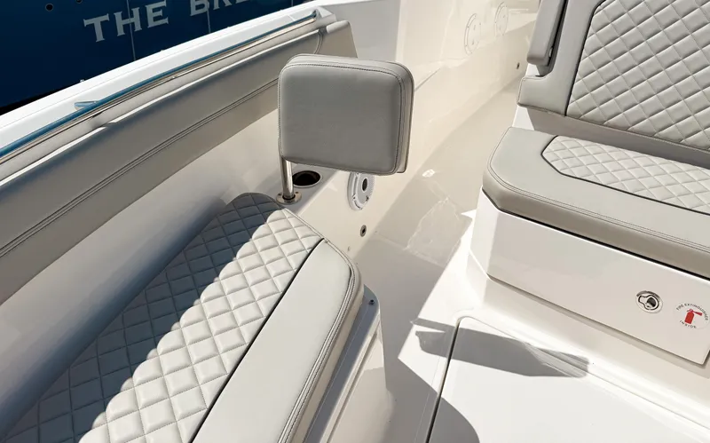 Slide: The Image of 2024 Pursuit S 288 Sport boat interior with quilted seating and armrest. - 14