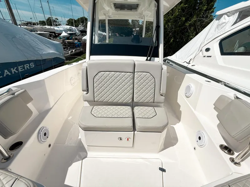 Slide: The Image of 2024 Pursuit S 288 Sport boat interior with cushioned seating and modern design. - 16