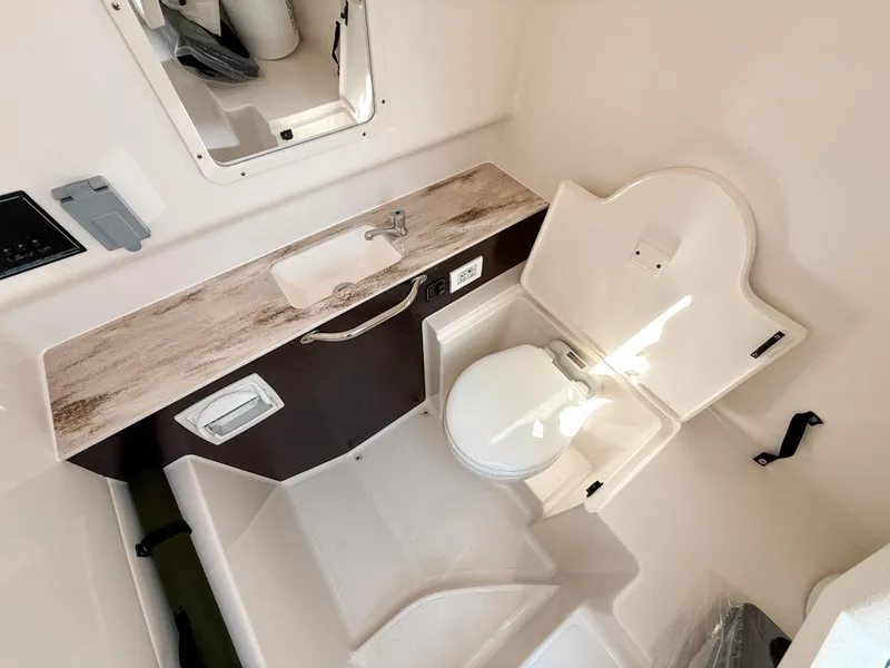 Slide: The Image of 2024 Pursuit S 288 Sport boat bathroom with sink and toilet. - 18