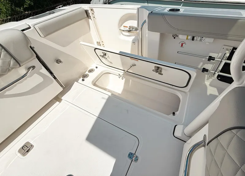 Slide: The Image of 2024 Pursuit S 288 Sport boat interior with open storage compartments and seating. - 19