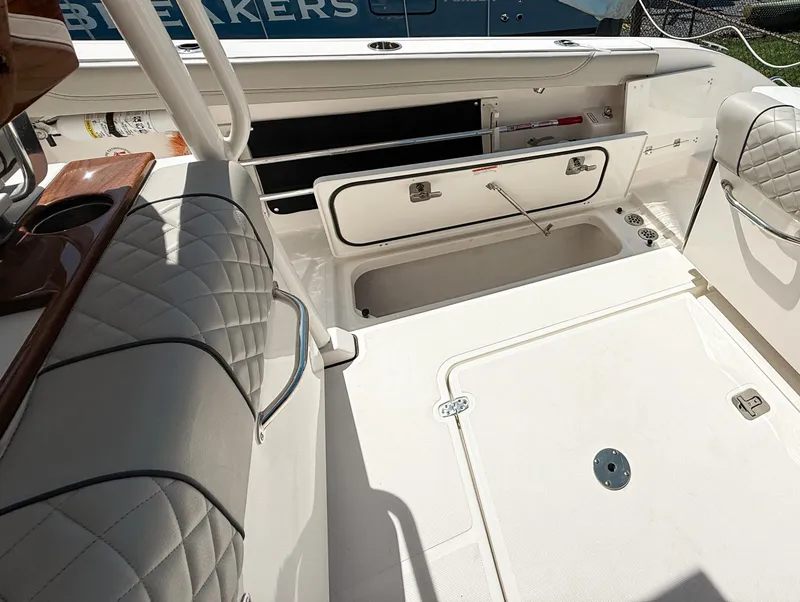 Slide: The Image of 2024 Pursuit S 288 Sport boat interior with open storage compartments and quilted seating. - 21