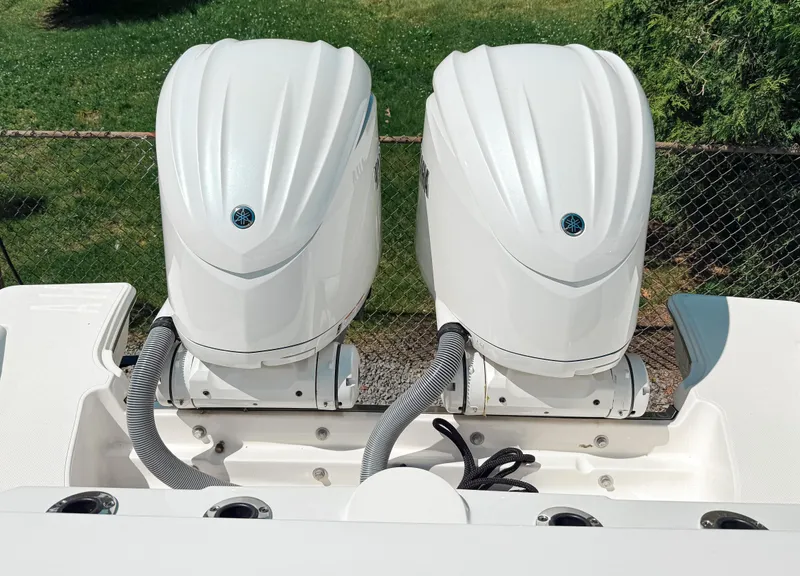 Slide: The Image of 2024 Pursuit S 288 Sport boat with dual outboard engines, viewed from the rear. - 3