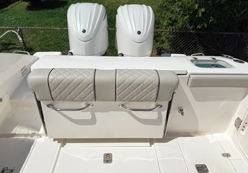 Slide: The Image of 2024 Pursuit S 288 Sport boat with dual engines and cushioned seating. - 4