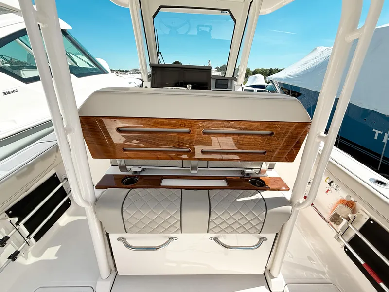 Slide: The Image of 2024 Pursuit S 288 Sport boat interior with luxurious seating and wood accents. - 6