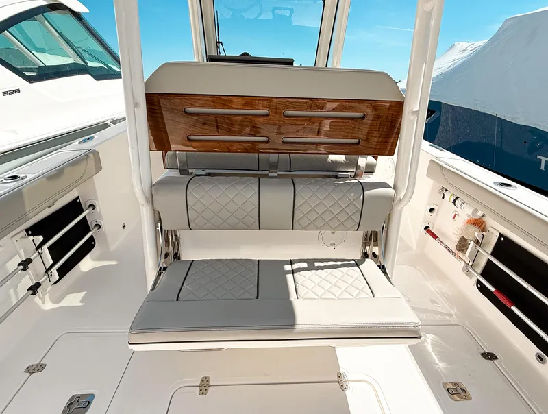 Slide: The Image of 2024 Pursuit S 288 Sport boat interior with cushioned seating and sleek design. - 7
