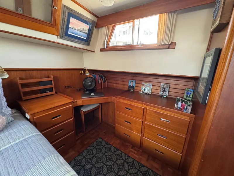 Slide: The Image of Interior of 2000 Grand Banks 42 Classic with wooden furniture and desk. - 13