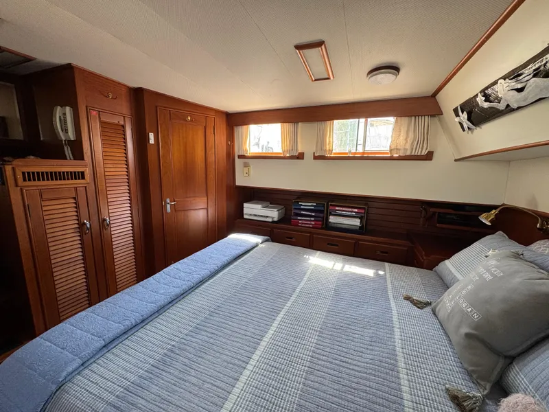 Slide: The Image of Interior of 2000 Grand Banks 42 Classic yacht featuring a cozy bedroom. - 14