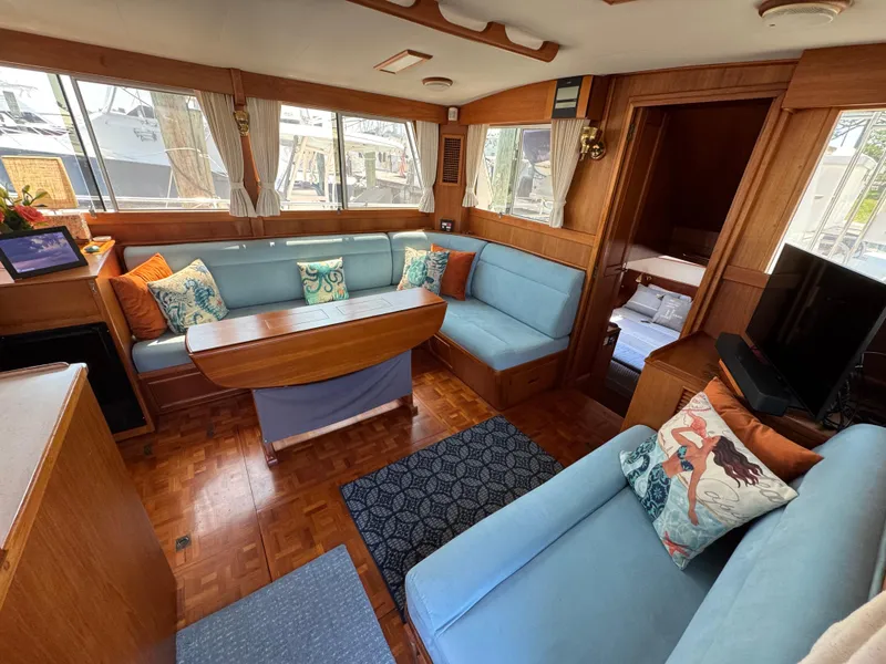 Slide: The Image of Interior of 2000 Grand Banks 42 Classic yacht with blue sofas. - 2