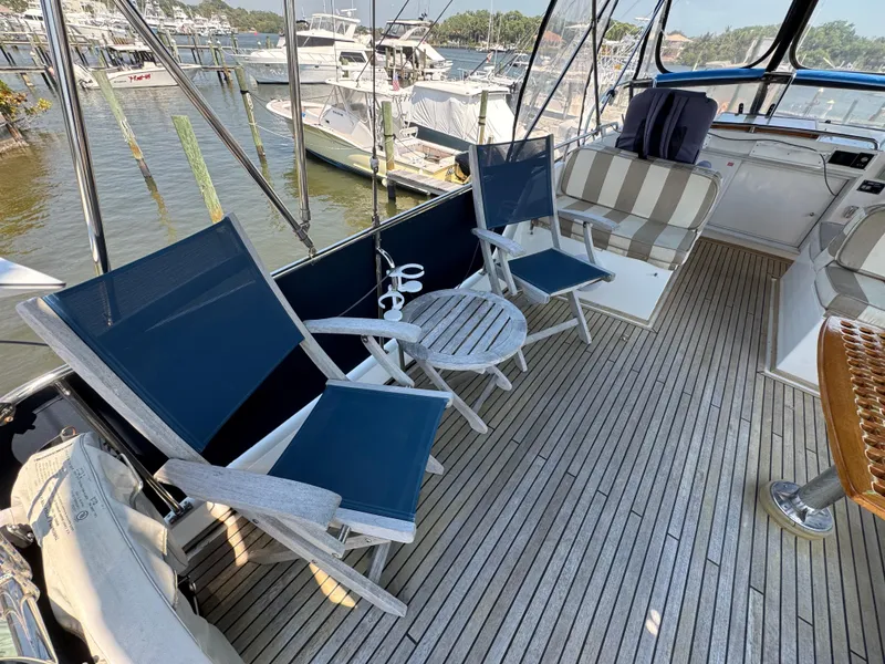 Slide: The Image of Deck area of 2000 Grand Banks 42 Classic yacht with blue chairs. - 39