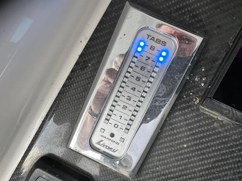 Slide: The Image of Trim tab control panel on 2019 Fountain 39 NX boat dashboard. - 10