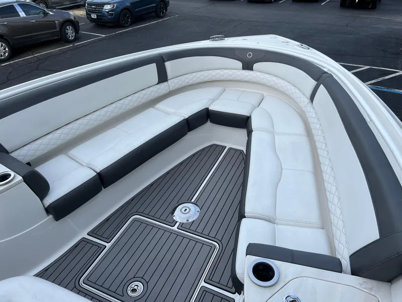 Slide: The Image of 2019 Fountain 39 NX boat with spacious white and gray seating in a parking lot. - 12