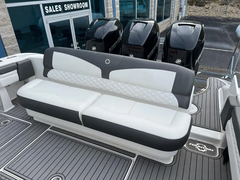 Slide: The Image of 2019 Fountain 39 NX boat with cushioned seating and powerful outboard motors near sales showroom. - 15