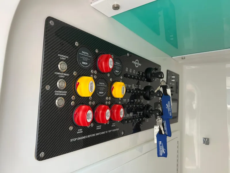 Slide: The Image of Control panel of a 2019 Fountain 39 NX boat with labeled switches and keys. - 19