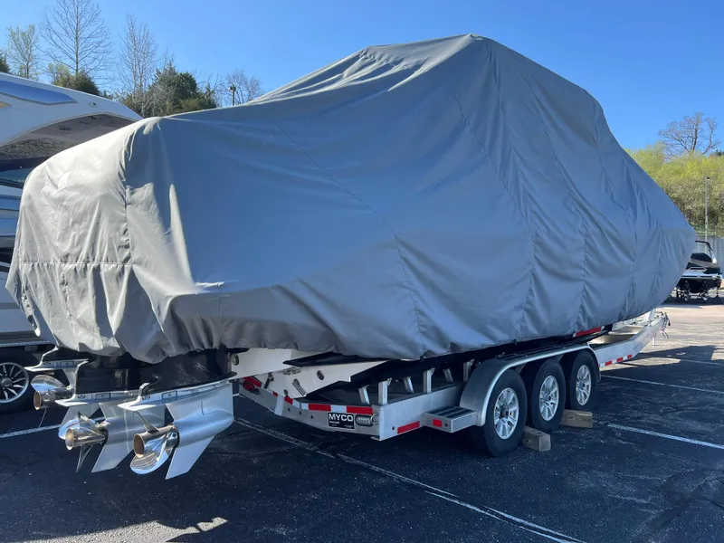 Slide: The Image of Covered 2019 Fountain 39 NX boat on trailer, parked outdoors under clear sky. - 24