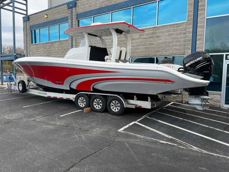Slide: The Image of 2019 Fountain 39 NX boat with red and white design on a trailer, parked outside a building. - 3
