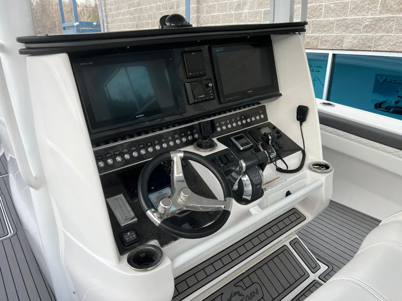 Slide: The Image of Control panel of a 2019 Fountain 39 NX boat with steering wheel and electronic displays. - 5