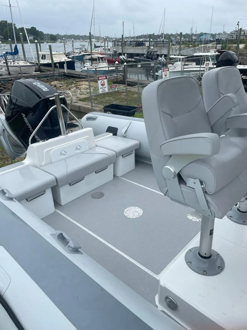 Slide: The Image of 2023 Protector 250 Chase boat interior with seating, docked at marina. - 14